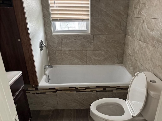 3307 Askew Ave, Kansas City, MO 64128 - full bathroom featuring vanity, tiled shower / bath combo, and wood finished floors
