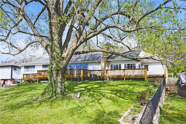 13 P Lake Shore Dr, Lake Lotawana, MO 64086 - back of house with a wooden deck and a lawn