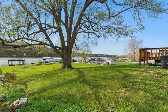 13 P Lake Shore Dr, Lake Lotawana, MO 64086 - view of green lawn featuring a deck with water view and a boat dock