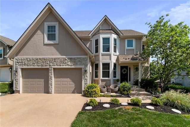 9000 W 127th Ter, Overland Park, KS 66213 - view of front facade featuring stucco siding, stone siding, driveway, and an attached garage