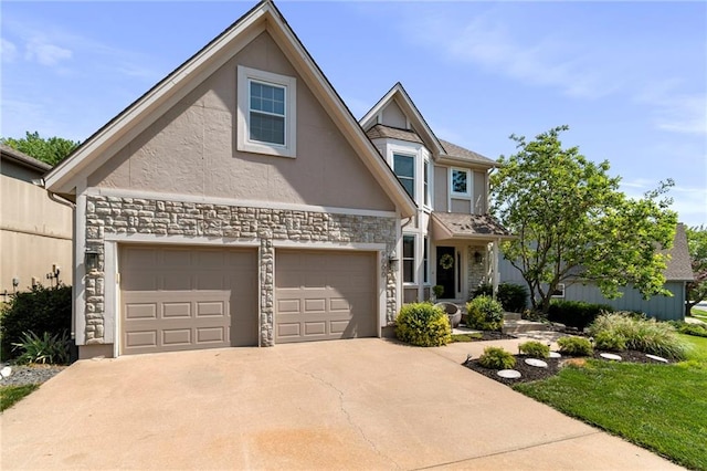 9000 W 127th Ter, Overland Park, KS 66213 - view of front of home with stone siding, stucco siding, concrete driveway, and a garage