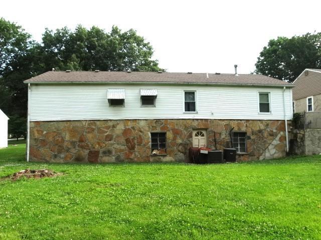 503 Hickory St, Richmond, MO 64085 - rear view of property featuring stone siding and a yard