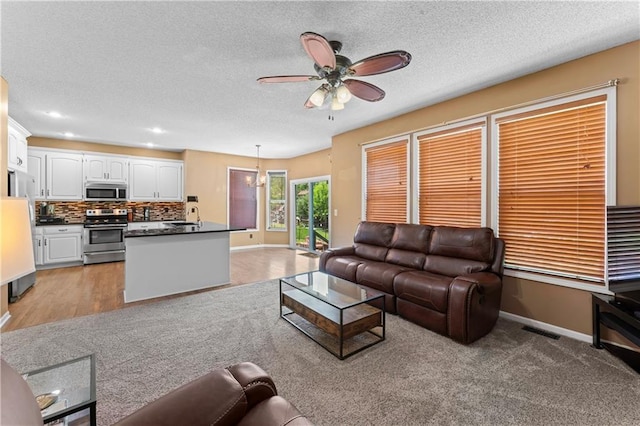 20112 W 220th St, Spring Hill, KS 66083 - living room with ceiling fan, a textured ceiling, and recessed lighting