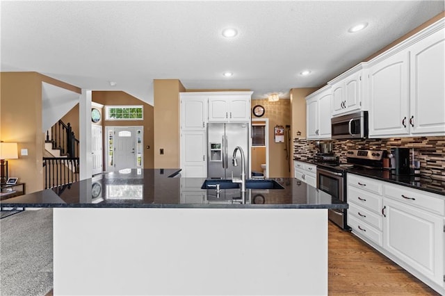 20112 W 220th St, Spring Hill, KS 66083 - kitchen featuring stainless steel appliances, an island with sink, white cabinetry, recessed lighting, and decorative backsplash