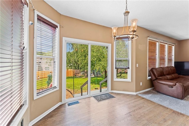 20112 W 220th St, Spring Hill, KS 66083 - doorway with wood finished floors, a chandelier, and a textured ceiling