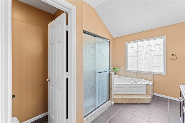 20112 W 220th St, Spring Hill, KS 66083 - bathroom with a shower stall, a garden tub, vaulted ceiling, and tile patterned flooring
