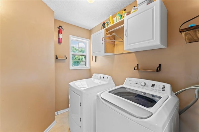 20112 W 220th St, Spring Hill, KS 66083 - laundry room featuring cabinet space, washing machine and dryer, and a textured ceiling