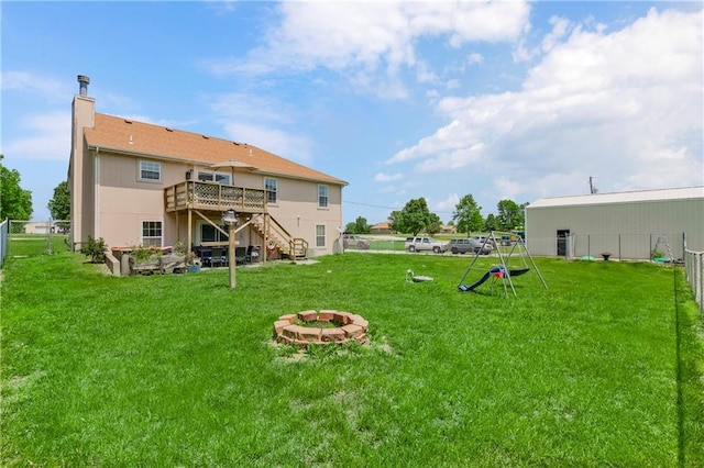 15375 Roger Rd, Leavenworth, KS 66048 - rear view of house featuring a fire pit, stairway, a wooden deck, and a chimney