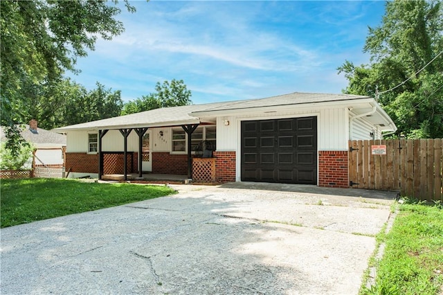 12603 E 37th St N, Sugar Creek, MO 64050 - ranch-style home featuring concrete driveway, brick siding, an attached garage, and a porch