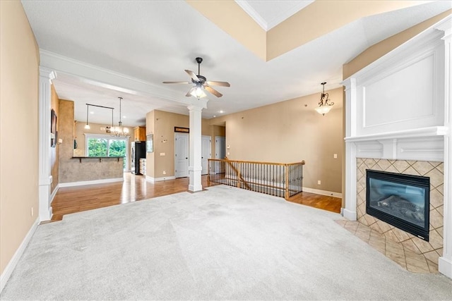 15723 W 61st Ter, Shawnee, KS 66217 - unfurnished living room with light carpet, a fireplace, ceiling fan, crown molding, and ornate columns