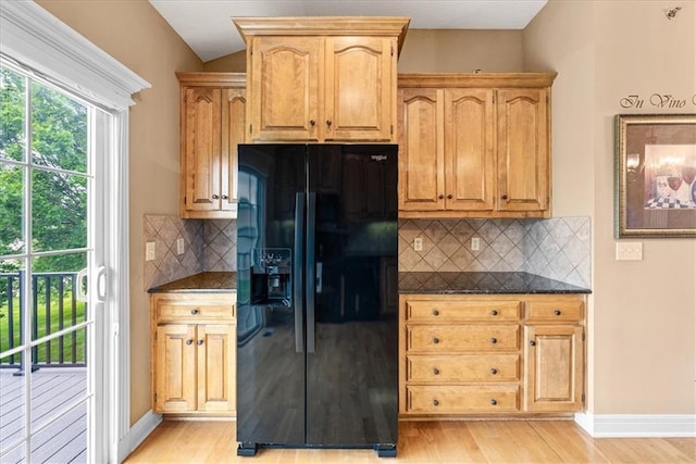 15723 W 61st Ter, Shawnee, KS 66217 - kitchen featuring black refrigerator with ice dispenser, light wood finished floors, and tasteful backsplash