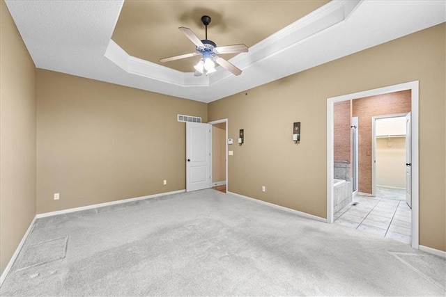 15723 W 61st Ter, Shawnee, KS 66217 - unfurnished bedroom with a raised ceiling, light carpet, a ceiling fan, and connected bathroom
