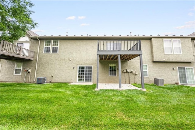 15723 W 61st Ter, Shawnee, KS 66217 - back of property featuring a balcony, stucco siding, a patio area, and a yard