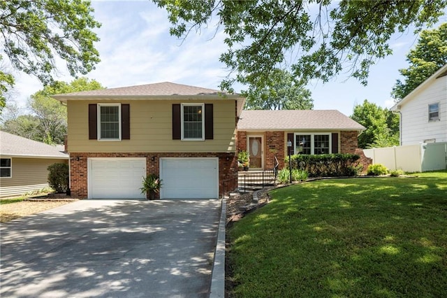 315 Goodrich Dr, Warrensburg, MO 64093 - tri-level home featuring brick siding, a garage, and driveway