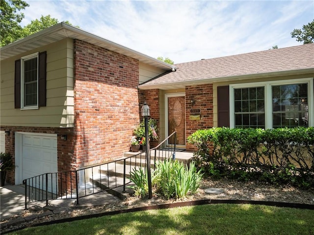 315 Goodrich Dr, Warrensburg, MO 64093 - view of front facade with brick siding and an attached garage