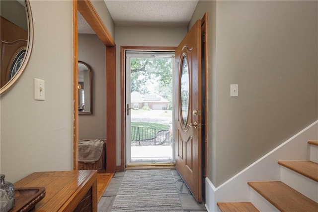 315 Goodrich Dr, Warrensburg, MO 64093 - entrance foyer featuring stairway and a textured ceiling