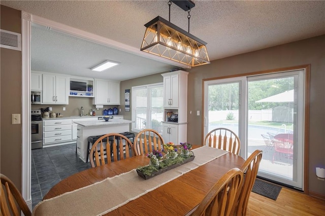 315 Goodrich Dr, Warrensburg, MO 64093 - dining space featuring a textured ceiling