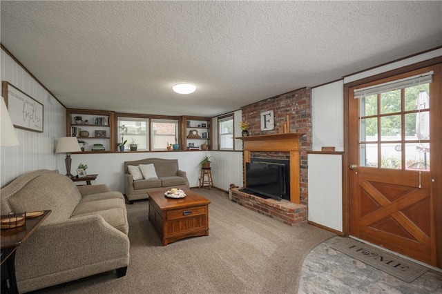 315 Goodrich Dr, Warrensburg, MO 64093 - living area featuring a textured ceiling, a fireplace, and carpet