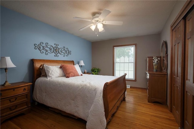 315 Goodrich Dr, Warrensburg, MO 64093 - bedroom featuring light wood-style floors, a closet, and a ceiling fan