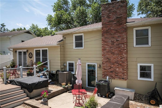 315 Goodrich Dr, Warrensburg, MO 64093 - back of house featuring a deck, a chimney, and a patio