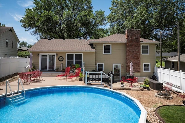 315 Goodrich Dr, Warrensburg, MO 64093 - view of pool with a fire pit, a fenced backyard, and a patio area