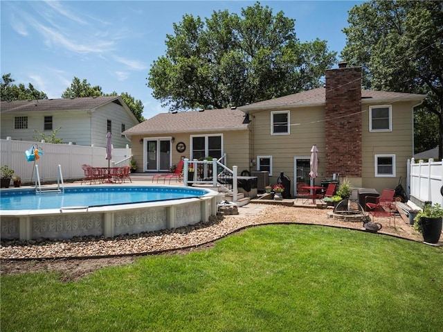 315 Goodrich Dr, Warrensburg, MO 64093 - back of property with a chimney and a wooden deck