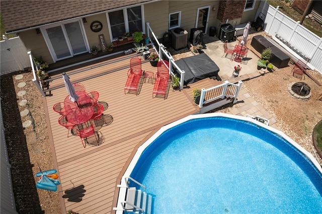 315 Goodrich Dr, Warrensburg, MO 64093 - view of pool with a wooden deck, a fenced backyard, and a patio