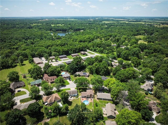 315 Goodrich Dr, Warrensburg, MO 64093 - aerial view of residential area with a forest and property parcel outlined
