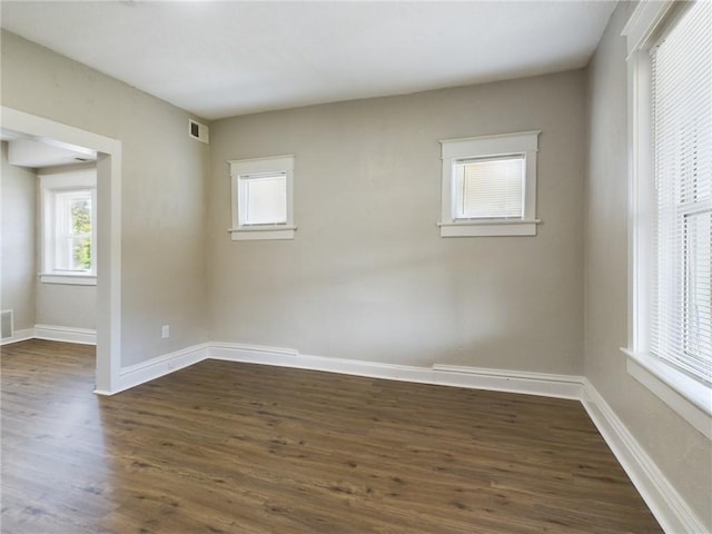 2416 E 22nd St, Kansas City, MO 64127 - empty room featuring dark wood-type flooring and baseboards