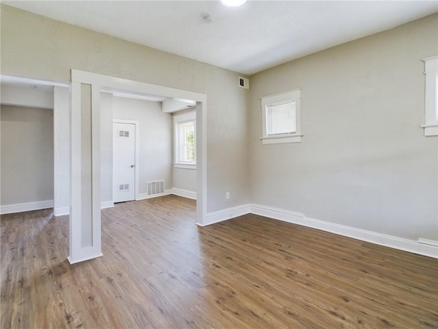 2416 E 22nd St, Kansas City, MO 64127 - unfurnished room featuring wood finished floors and baseboards