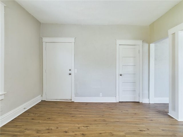 2416 E 22nd St, Kansas City, MO 64127 - unfurnished bedroom featuring wood finished floors