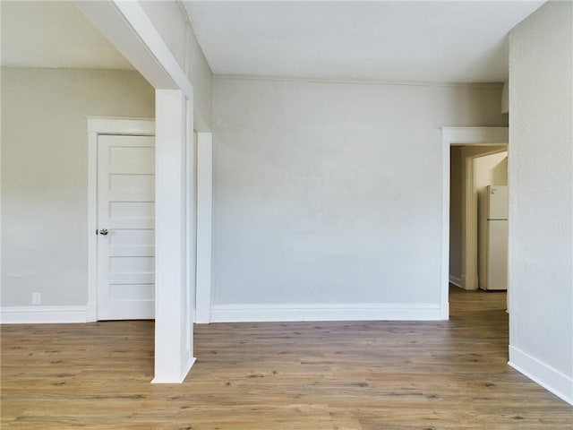 2416 E 22nd St, Kansas City, MO 64127 - empty room featuring wood finished floors and baseboards
