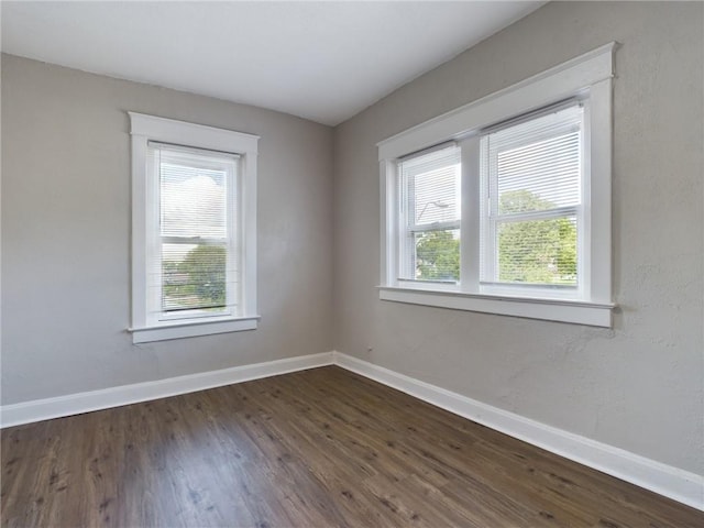 2416 E 22nd St, Kansas City, MO 64127 - spare room with dark wood-style floors