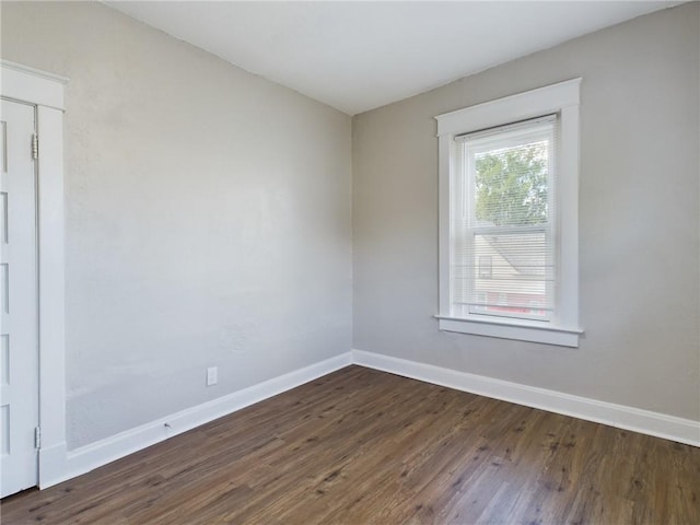 2416 E 22nd St, Kansas City, MO 64127 - unfurnished room with dark wood-style floors and baseboards