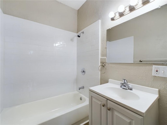 2416 E 22nd St, Kansas City, MO 64127 - bathroom with a textured wall, vanity, and shower / bath combination