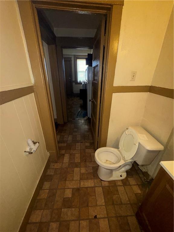 2416 E 22nd St, Kansas City, MO 64127 - bathroom with brick patterned flooring and vanity