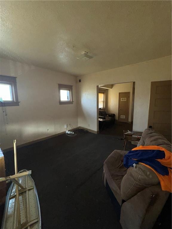 2416 E 22nd St, Kansas City, MO 64127 - living room featuring a textured ceiling and plenty of natural light