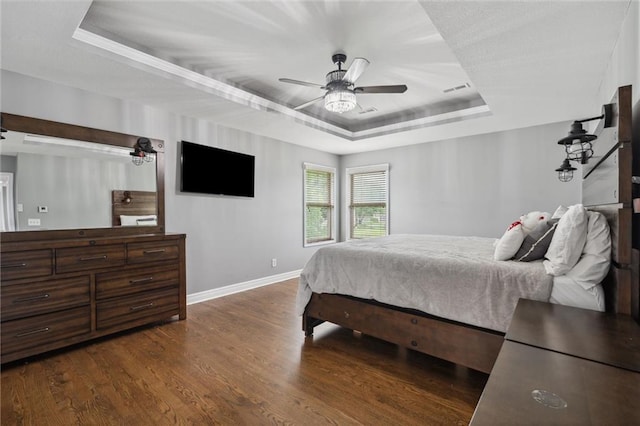 514 NE Viewpark Dr, Lees Summit, MO 64086 - bedroom featuring a tray ceiling, wood finished floors, and a ceiling fan