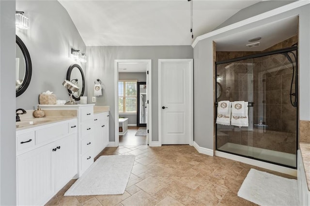 514 NE Viewpark Dr, Lees Summit, MO 64086 - bathroom with vanity, a shower stall, stone finish floors, and vaulted ceiling