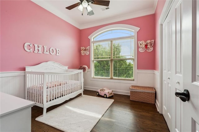 514 NE Viewpark Dr, Lees Summit, MO 64086 - bedroom featuring wainscoting, a nursery area, wood finished floors, a closet, and crown molding