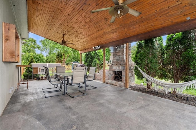 514 NE Viewpark Dr, Lees Summit, MO 64086 - view of patio with an outdoor stone fireplace, outdoor dining area, and ceiling fan