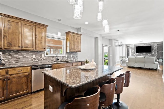 514 NE Viewpark Dr, Lees Summit, MO 64086 - kitchen featuring stainless steel dishwasher, a kitchen bar, a kitchen island, and plenty of natural light