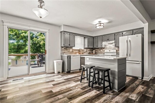 2004 NE Wien Ave, Blue Springs, MO 64029 - kitchen with white appliances, under cabinet range hood, light countertops, and plenty of natural light