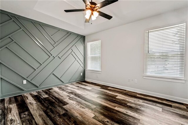 2004 NE Wien Ave, Blue Springs, MO 64029 - unfurnished bedroom featuring wood finished floors, multiple windows, and ceiling fan