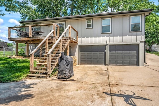 2004 NE Wien Ave, Blue Springs, MO 64029 - view of front facade featuring driveway, a garage, a deck, and stairway