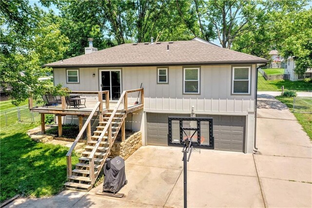 2004 NE Wien Ave, Blue Springs, MO 64029 - rear view of house featuring driveway, a garage, a deck, stairway, and roof with shingles