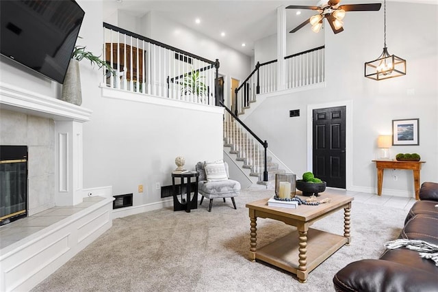 29500 W 184th St, Gardner, KS 66030 - carpeted living room featuring a towering ceiling, a ceiling fan, stairway, a fireplace, and recessed lighting