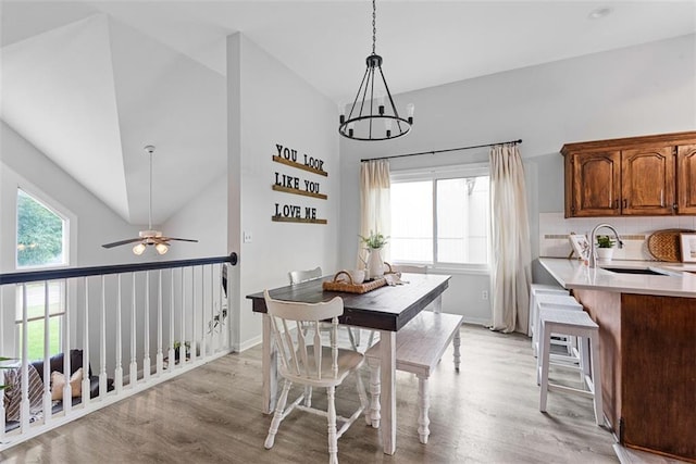 29500 W 184th St, Gardner, KS 66030 - dining space with light wood-style flooring, ceiling fan, a chandelier, and high vaulted ceiling