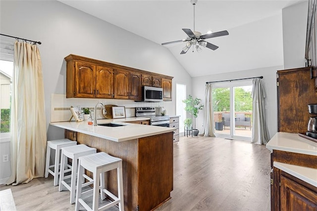 29500 W 184th St, Gardner, KS 66030 - kitchen with stainless steel appliances, a ceiling fan, light wood-style flooring, tasteful backsplash, and light countertops