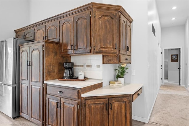29500 W 184th St, Gardner, KS 66030 - kitchen featuring light countertops, decorative backsplash, freestanding refrigerator, light colored carpet, and recessed lighting